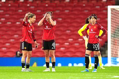 Manchester United's Maya Le Tissier, center, and teammates look dejected following Bayern Munich's second goal of the game during the Women's Champions League match between Manchester United and Bayern Munich in Manchester, England.