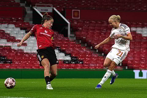 Bayern Munich's Pernille Harder, right, scores their side's first goal of the game during the Women's Champions League match between Manchester United and Bayern Munich in Manchester, England.