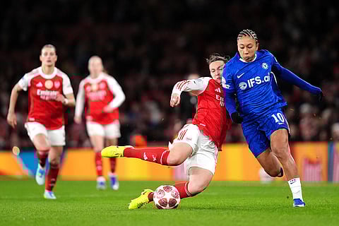 Arsenal's Lotte Wubben-Moy, left, and Chelsea's Lauren James battle for the ball during the Women's Champions League soccer match between Arsenal and Chelsea in London.