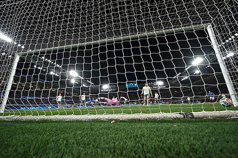 Northern Ireland goalkeeper Pierce Charles dives to stop a shot by Italy's Moise Kean who scored his side's second goal during the World Cup qualifying play-off soccer match between Italy and Northern Ireland, in Bergamo, Italy.