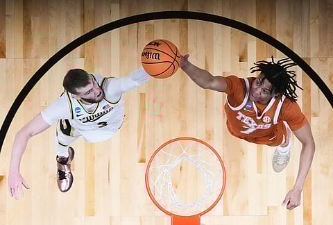 Texas guard Simeon Wilcher (7) works for a rebound against Purdue guard Braden Smith (3) during the second half in the Sweet 16 of the NCAA college basketball tournament against Texas in San Jose, California. 