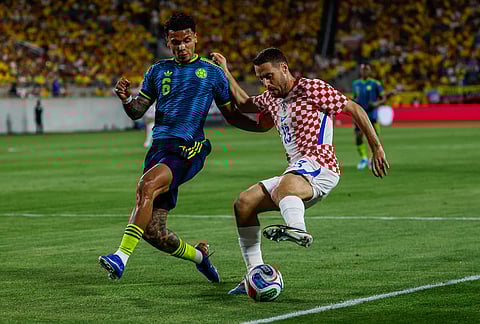 Croatia midfielder Nikola Vlasic (13) controls the ball against Colombia defender Santiago Arias (6) during the first half of an international friendly soccer game, in Orlando, Florida.