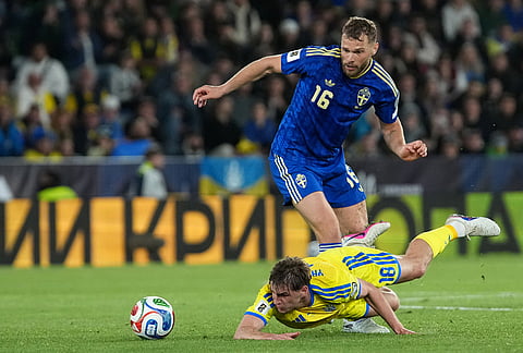 Sweden's Jesper Karlstrom, top, and Ukraine's Yehor Yarmoliuk challenge for the ball during a World Cup playoff semifinal soccer match between Ukraine and Sweden in Valencia, Spain.