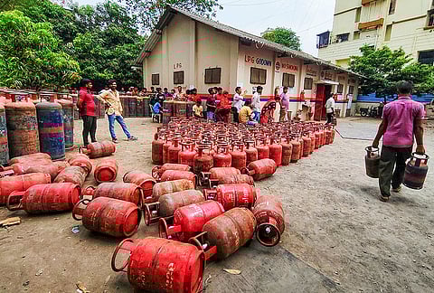 People gather at a gas agency to avail LPG cylinders, in Navi Mumbai.