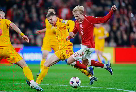 North Macedonia's Andrej Stojcevski and Denmark's Victor Froholdt, right, in action during the World Cup playoff semifinal soccer match between Denmark and North Macedonia in Copenhagen.