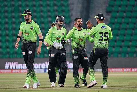 Lahore Qalandars' Sikandar Raza, second right, celebrates with teammates after taking the wicket of Hyderabad Kingsmen Marnus Labuschagne during the opening cricket match of the Pakistan Super League between Lahore Qalandars and Hyderabad Kingsmen, which taking place without spectators, in Lahore, Pakistan.