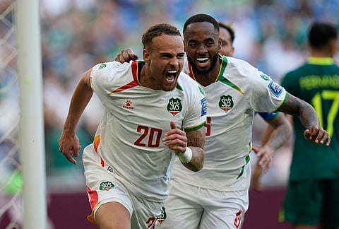 Suriname's Liam van Genderen, front, celebrates scoring his side's opening goal during a World Cup playoff semifinal soccer match between Bolivia and Suriname in Monterrey, Mexico.