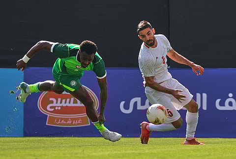 Iran's Milad Mohammadi, right, battles for the ball with Nigeria's Bright Osayi-Samuel during a friendly soccer match between Iran and Nigeria in Antalya, southern Turkey.