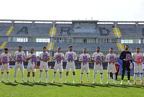 Iran's players sing the national anthem holding school bags, symbolizing children allegedly killed in a U.S. strike on a school in Minab, before a friendly soccer match between Iran and Nigeria, in Antalya, southern Turkey.