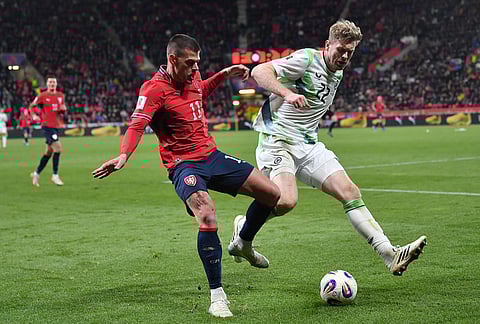 Czech Republic's Jan Kliment, left, and Ireland's Nathan Collins fight for the ball during a World Cup playoff semifinal soccer match between the Czech Republic and Ireland in Prague, Czech Republic.
