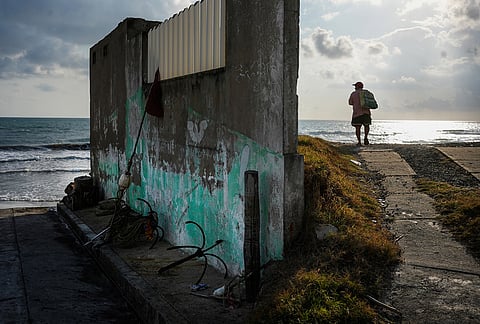 A fisherman stands on the shore after suspending fishing trips because of an oil spill in the Gulf of Mexico that authorities said originated from an unidentified vessel and two natural oil seeps, in Salinas, Mexico.