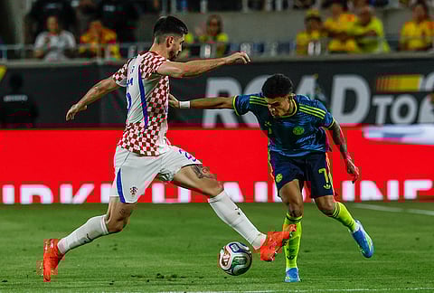 Croatia forward Igor Matanovic, left, and Colombia defender Johan Mojica (7) fight for the ball during the second half of an international friendly soccer game, in Orlando, Florida.