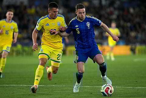 Sweden's Gabriel Gudmundsson, right, and Ukraine's Oleksandr Tymchyk challenge for the ball during a World Cup playoff semifinal soccer match between Ukraine and Sweden in Valencia, Spain.