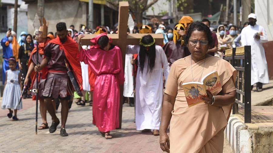 Christian procession reenacting Jesus carrying the cross during a street religious event.