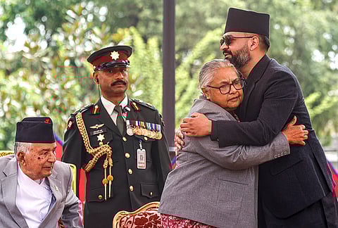 Nepal's newly appointed Prime Minister Balendra Shah, right, hugs outgoing interim Prime Minister Sushila Karki during his swearing-in ceremony at the President’s residence, in Kathmandu, Nepal.