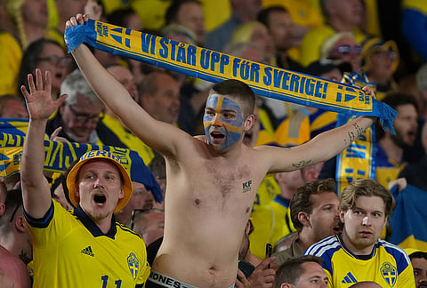 Sweden fans celebrate at the end of the World Cup playoff semifinal soccer match between Ukraine and Sweden in Valencia, Spain.