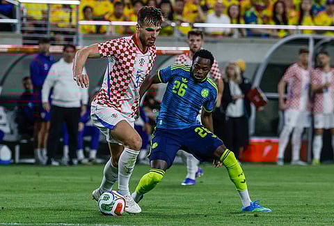 Croatia defender Marin Pongracic, left, is defended by Colombia forward Andres Gomez (26) during the second half of an international friendly soccer game in Orlando, Florida.
