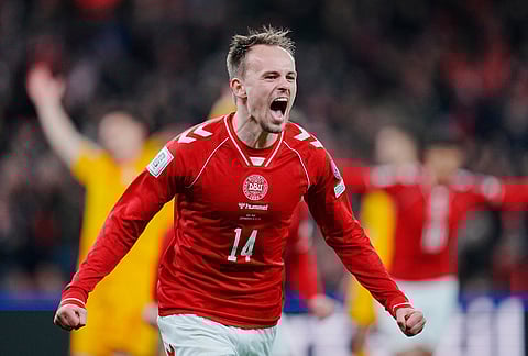 Denmark's Mikkel Damsgaard celebrates scoring a goal during the World Cup playoff semifinal soccer match between Denmark and North Macedonia in Copenhagen.