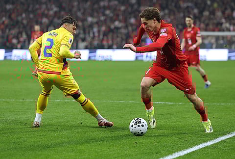 Turkey's Kenan Yildiz, right, vies for the ball with Romania's Andrei Ratiu during the 2026 World Cup playoff semifinal soccer match between Turkey and Romania, in Istanbul, Turkey.