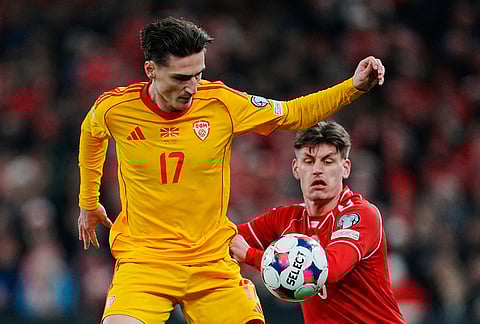 North Macedonia's Lirim Qamili and Denmark's Joachim Maehle, right, in action during the World Cup playoff semifinal soccer match between Denmark and North Macedonia in Copenhagen.