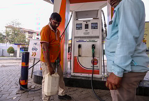 A worker fills a container at a petrol pump amid rumours of fuel shortage in the wake of the West Asian conflict, in Prayagraj, Uttar Pradesh.