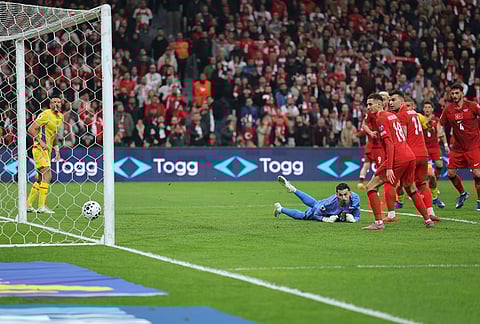 Turkey's goalkeeper Ugurcan Cakir, bottom, looks as the ball hits the pole of the goal during the 2026 World Cup playoff semifinal soccer match between Turkey and Romania, in Istanbul, Turkey.
