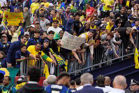 Fans greet players as they leave the pitch at half time of the international friendly soccer match between Brazil and France in Foxborough, Mass.