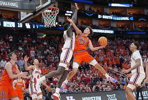 Illinois guard Keaton Wagler (23) shoots as Houston forward Kalifa Sakho (14) defends during the first half in the Sweet 16 of the NCAA college basketball tournament in Houston. 