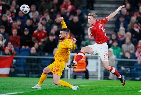 Denmark's Rasmus Hojlund, right, and North Macedonia's Gjoko Zajkov in action during the World Cup playoff semifinal soccer match between Denmark and North Macedonia in Copenhagen.