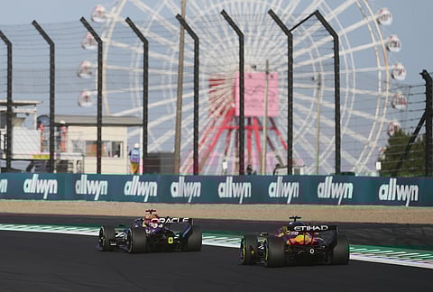 Red Bull driver Max Verstappen of the Netherlands, left, and McLaren driver Oscar Piastri of Australia steer their car during the second practice session of the Japanese Formula One Grand Prix in Suzuka, Japan.