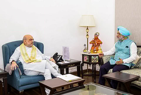 Union Home Minister Amit Shah, left, interacts with Delhi LG Taranjit Singh Sandhu, in New Delhi. 
