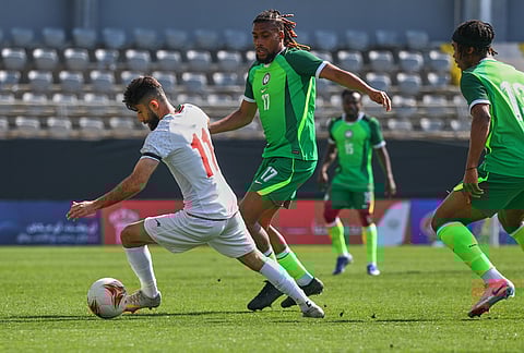 Iran's Ali Gholizadeh, left, vies for the ball with Nigeria's Alex Iwobi during a friendly soccer match between Iran and Nigeria in Antalya, southern Turkey.
