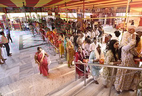 People queue up at the 'Mahavir Mandir' to offer prayers, in Patna, Bihar.