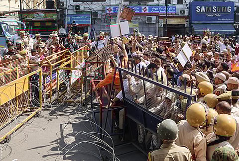 Police personnel barricade a road as Bhartiya Janta Yuva Morcha and BJP activists take out a protest march towards the Civil Secretariat demanding the establishment of National Law University (NLU), in Jammu.