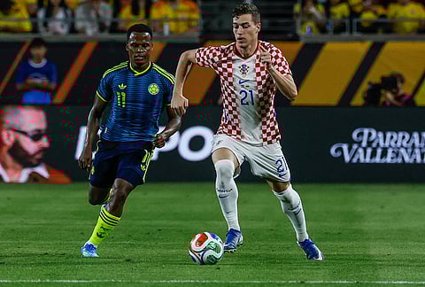 Croatia forward Ivan Perisic (21) brings the ball down the pitch against Colombia defender Yerson Mosquera (11) during the second half of an international friendly soccer game, in Orlando, Florida.