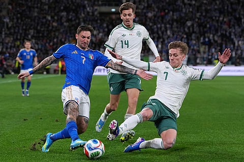 Italy's Matteo Politano, left, Northern Ireland's Isaac Price, center, and Northern Ireland's Ethan Galbraith vie for the ball during the World Cup qualifying play-off soccer match between Italy and Northern Ireland, in Bergamo, Italy.