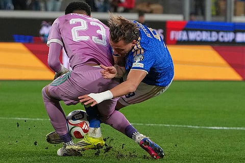 Northern Ireland goalkeeper Pierce Charles pulls a save on Italy's Mateo Retegui during the World Cup qualifying play-off soccer match between Italy and Northern Ireland, in Bergamo, Italy.