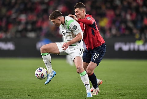 Ireland's Dara O'Shea, left, and Czech Republic's Patrik Schick fight for the ball during a World Cup playoff semifinal soccer match between the Czech Republic and Ireland in Prague, Czech Republic.