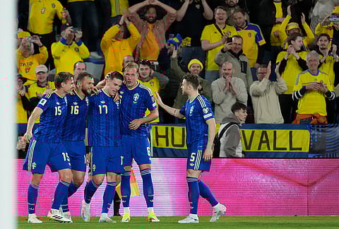 Sweden's Viktor Gyokeres celebrates with teammates after scoring his side's third goal during a World Cup playoff semifinal soccer match between Ukraine and Sweden in Valencia, Spain.