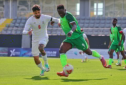 Nigeria's Akor Adams, right, fights for the ball with Iran's Mohammad Ghorbani during a friendly soccer match between Iran and Nigeria in Antalya, southern Turkey.