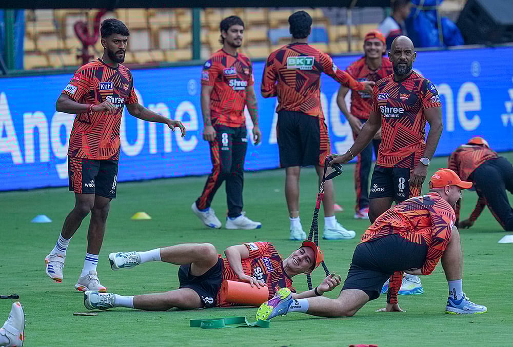 Sunrisers Hyderabad’s Pat Cummins with teammates during a practice session on the eve of the Indian Premier League (IPL) 2026 cricket match against Royal Challengers Bengaluru, at M Chinnaswamy Stadium in Bengaluru, Karnataka. - | Photo: PTI/Shailendra Bhojak