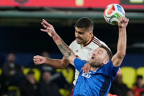 Spain's Rodri, top, and Serbia's Sergej Milinkovic-Savic challenge for the ball during the international friendly soccer match between Spain and Serbia in Villarreal, Spain.