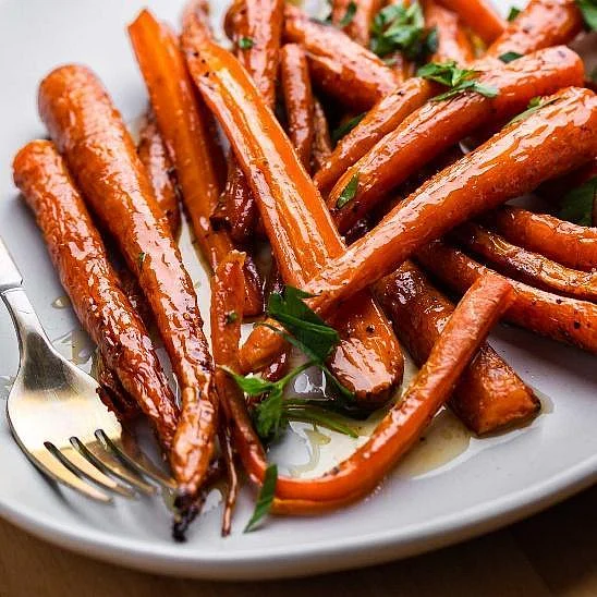 Maple roasted carrots with parsley and a fork