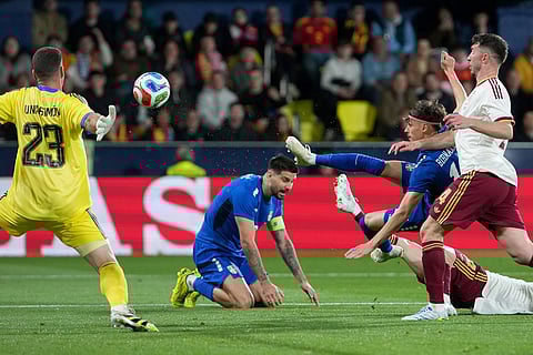 Spain's goalkeeper Unai Simon, left, makes a save in front of Serbia's Veljko Birmancevic, second right, during the international friendly soccer match between Spain and Serbia in Villarreal, Spain.