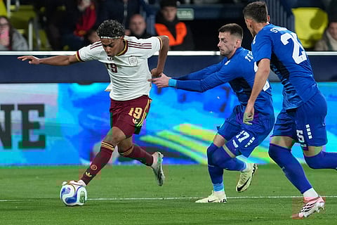 Spain's Lamine Yamal, left, and Serbia's Aleksa Terzic challenge for the ball during the international friendly soccer match between Spain and Serbia in Villarreal, Spain.