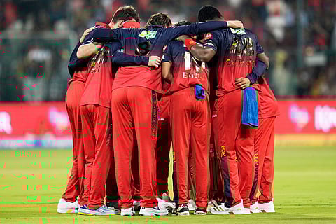 Royal Challengers Bengaluru players form a huddle before the start of the Indian Premier League cricket match between Royal Challengers Bengaluru and Sunrisers Hyderabad in Bengaluru, India.