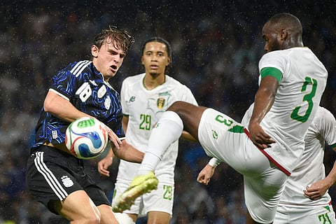 Argentina's Nicolas Paz, left, and Mauritania's Lamine Ba vie for the ball during a friendly match in Buenos Aires, Argentina.