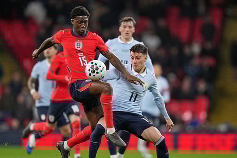 England's Kobbie Mainoo, left, shields the ball from Uruguay's Facundo Pellistri during the international friendly soccer match between England and Uruguay in London.