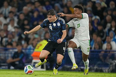 Argentina's Julian Alvarez and Mauritania's Beyatt Lekweiry battle for the ball during a friendly soccer match in Buenos Aires, Argentina.