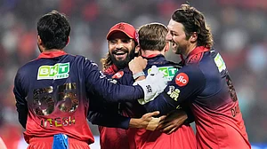 AP : Royal Challengers Bengaluru's Phil Salt, second right, back to the camera, celebrates with teammates after taking the catch to dismiss Sunrisers Hyderabad's captain Ishan Kishan during their Indian Premier League match.